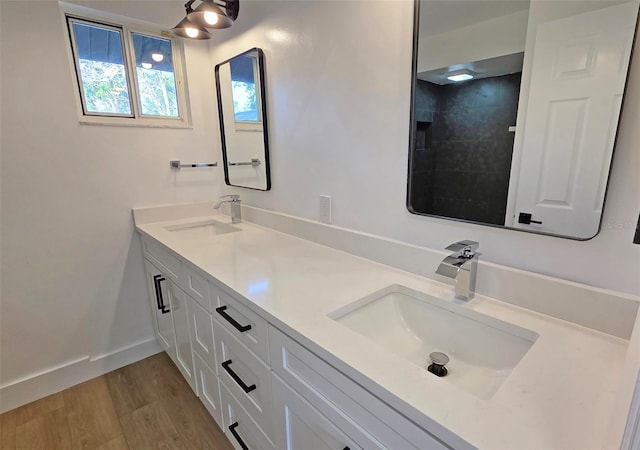 4074 Redbird Cir, Sarasota, FL 34231 - bathroom with double vanity, wood finished floors, and tiled shower