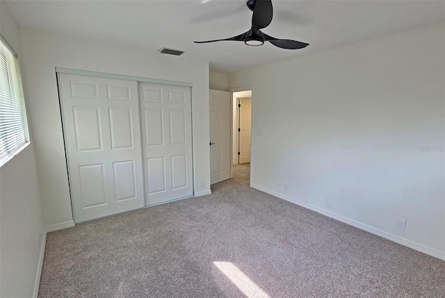 4074 Redbird Cir, Sarasota, FL 34231 - unfurnished bedroom featuring a closet, carpet flooring, and a ceiling fan