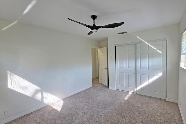 4074 Redbird Cir, Sarasota, FL 34231 - unfurnished bedroom with carpet flooring, a closet, and a ceiling fan