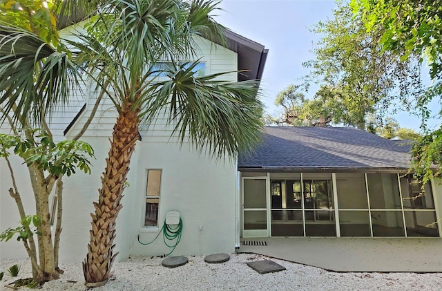 4074 Redbird Cir, Sarasota, FL 34231 - rear view of property with a shingled roof, a sunroom, stucco siding, and a patio
