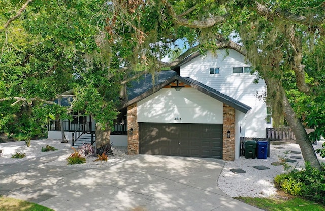 4074 Redbird Cir, Sarasota, FL 34231 - view of front facade featuring a garage, driveway, and brick siding