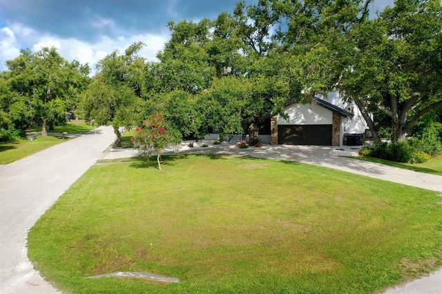 4074 Redbird Cir, Sarasota, FL 34231 - view of front of house featuring driveway, a front lawn, an attached garage, and brick siding