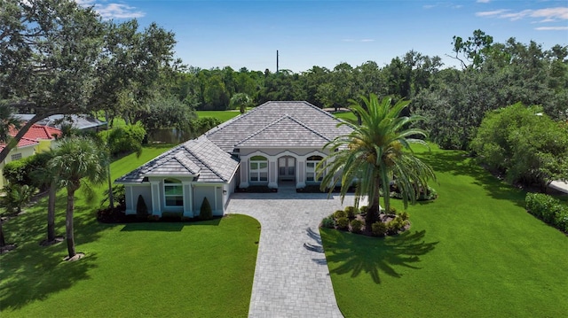 462 E Macewen Dr, Osprey, FL 34229 - mediterranean / spanish-style house with decorative driveway, a front lawn, and stucco siding