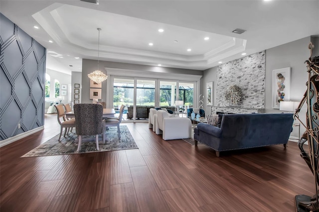 462 E Macewen Dr, Osprey, FL 34229 - living room with a tray ceiling, dark wood-style floors, a chandelier, and recessed lighting