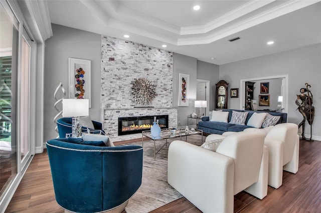 462 E Macewen Dr, Osprey, FL 34229 - living room with a tray ceiling, recessed lighting, a stone fireplace, wood finished floors, and crown molding