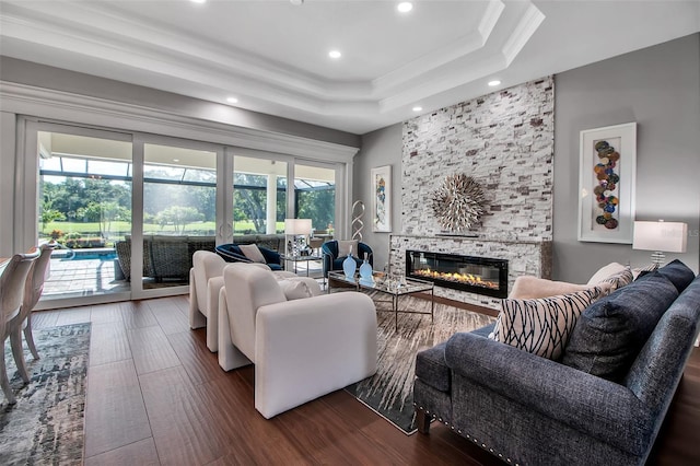 462 E Macewen Dr, Osprey, FL 34229 - living room featuring recessed lighting, a fireplace, a tray ceiling, wood finished floors, and crown molding