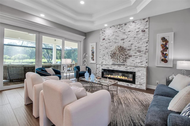 462 E Macewen Dr, Osprey, FL 34229 - living area featuring ornamental molding, a stone fireplace, recessed lighting, a tray ceiling, and wood finished floors