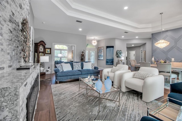 462 E Macewen Dr, Osprey, FL 34229 - living area with a chandelier, a raised ceiling, recessed lighting, dark wood-style floors, and crown molding