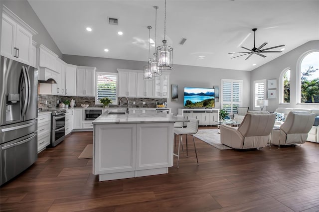 462 E Macewen Dr, Osprey, FL 34229 - kitchen with open floor plan, stainless steel appliances, white cabinetry, tasteful backsplash, and recessed lighting
