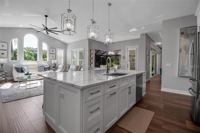 462 E Macewen Dr, Osprey, FL 34229 - kitchen with open floor plan, a chandelier, an island with sink, light stone counters, and appliances with stainless steel finishes