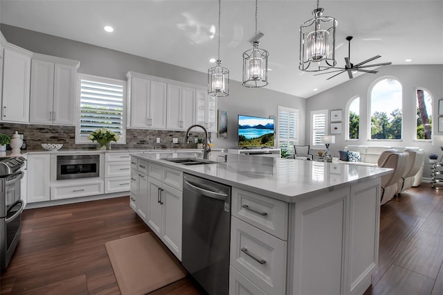 462 E Macewen Dr, Osprey, FL 34229 - kitchen featuring a chandelier, open floor plan, appliances with stainless steel finishes, white cabinetry, and tasteful backsplash