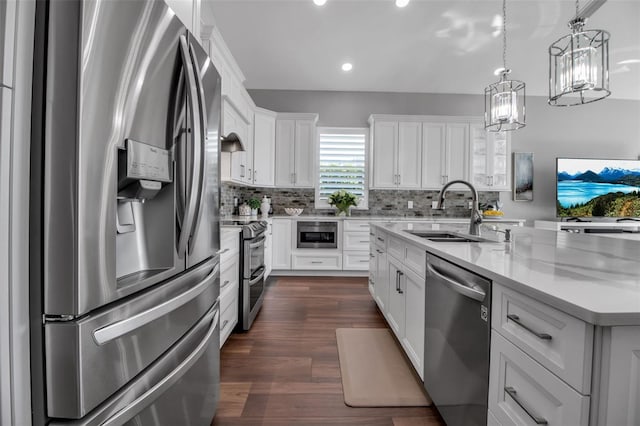 462 E Macewen Dr, Osprey, FL 34229 - kitchen featuring stainless steel appliances, tasteful backsplash, a center island with sink, white cabinets, and recessed lighting