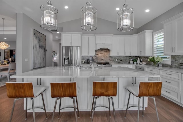 462 E Macewen Dr, Osprey, FL 34229 - kitchen featuring a chandelier, stainless steel fridge with ice dispenser, decorative backsplash, white cabinetry, and hanging light fixtures
