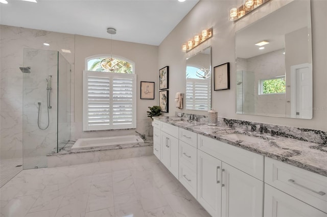 462 E Macewen Dr, Osprey, FL 34229 - full bath featuring marble look tiles, a bath, a marble finish shower, and double vanity