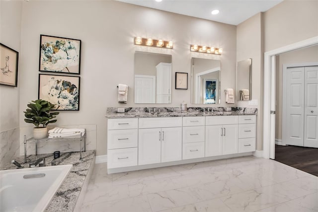 462 E Macewen Dr, Osprey, FL 34229 - full bathroom featuring double vanity, marble finish flooring, a bath, and recessed lighting