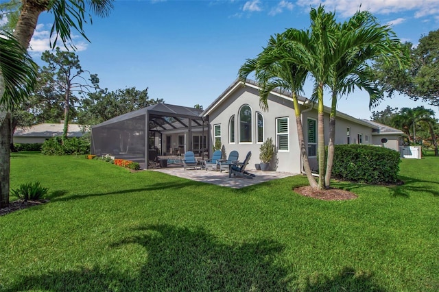 462 E Macewen Dr, Osprey, FL 34229 - back of property with a patio, a yard, stucco siding, and a lanai
