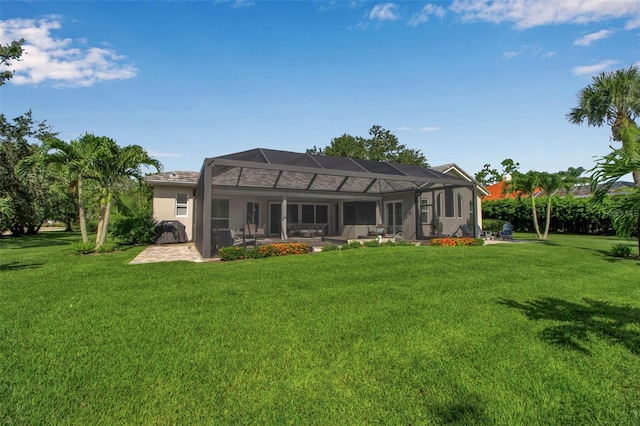 462 E Macewen Dr, Osprey, FL 34229 - rear view of property featuring a lawn, a patio, a lanai, and stucco siding