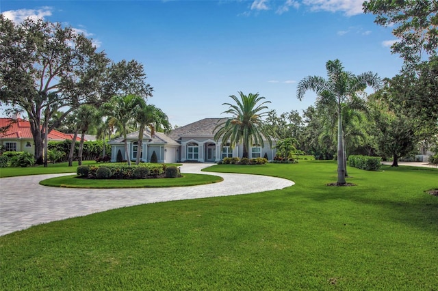 462 E Macewen Dr, Osprey, FL 34229 - view of front of house featuring curved driveway and a front yard