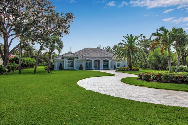 462 E Macewen Dr, Osprey, FL 34229 - view of front of house with a front lawn, stucco siding, and curved driveway