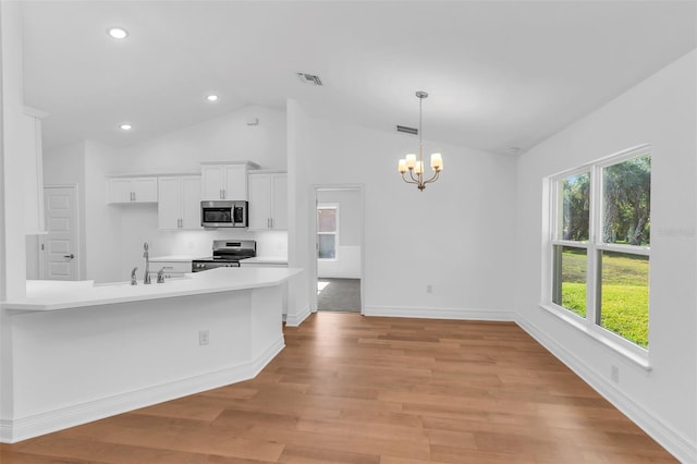 27471 Deep Creek Blvd, Punta Gorda, FL 33983 - kitchen with stainless steel appliances, a chandelier, white cabinets, light countertops, and light wood-style flooring