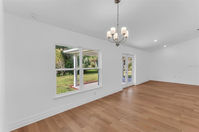27471 Deep Creek Blvd, Punta Gorda, FL 33983 - empty room featuring french doors, light wood-type flooring, plenty of natural light, and recessed lighting