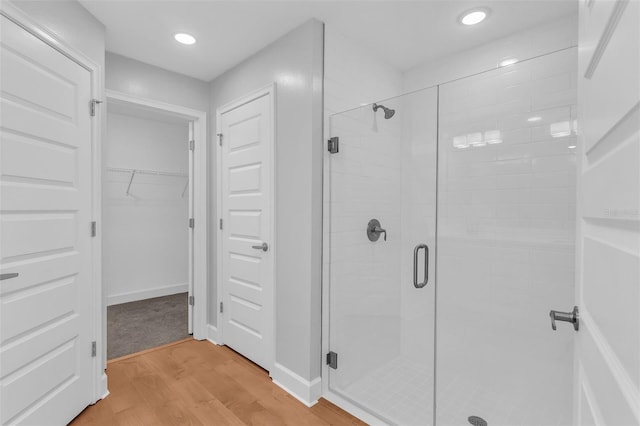 27471 Deep Creek Blvd, Punta Gorda, FL 33983 - bathroom with a shower stall, wood finished floors, a walk in closet, and recessed lighting