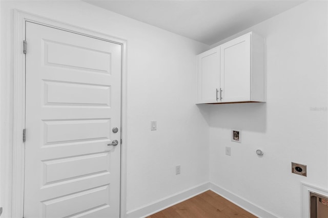 27471 Deep Creek Blvd, Punta Gorda, FL 33983 - washroom featuring hookup for an electric dryer, cabinet space, wood finished floors, hookup for a washing machine, and hookup for a gas dryer