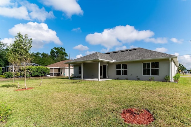 27471 Deep Creek Blvd, Punta Gorda, FL 33983 - rear view of property featuring a patio area, stucco siding, a lawn, and roof with shingles
