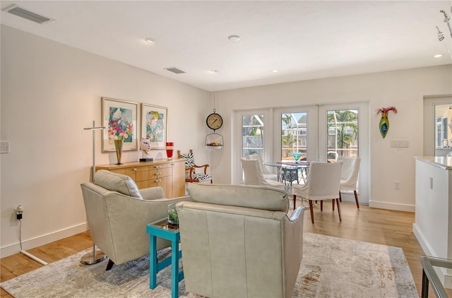 6308 4th Ave NW, Bradenton, FL 34209 - living room featuring light wood-type flooring and recessed lighting