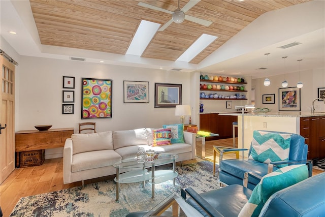 6308 4th Ave NW, Bradenton, FL 34209 - living area featuring wooden ceiling, light wood-style floors, vaulted ceiling, and a skylight