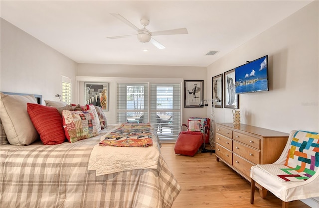 6308 4th Ave NW, Bradenton, FL 34209 - bedroom with light wood finished floors, multiple windows, and ceiling fan