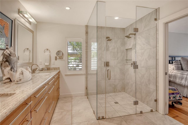 6308 4th Ave NW, Bradenton, FL 34209 - ensuite bathroom featuring double vanity, a stall shower, tile patterned floors, and recessed lighting