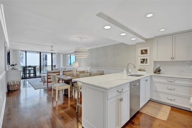 6480 Midnight Pass Rd Unit 211, Sarasota, FL 34242 - kitchen with a peninsula, wood finished floors, dishwasher, white cabinetry, and crown molding