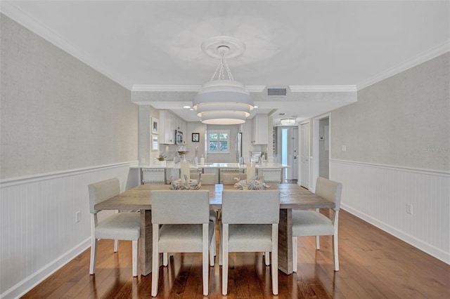 6480 Midnight Pass Rd Unit 211, Sarasota, FL 34242 - dining room with hardwood / wood-style flooring, a wainscoted wall, and ornamental molding