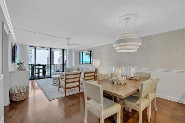 6480 Midnight Pass Rd Unit 211, Sarasota, FL 34242 - dining space featuring hardwood / wood-style flooring, crown molding, wainscoting, and ceiling fan