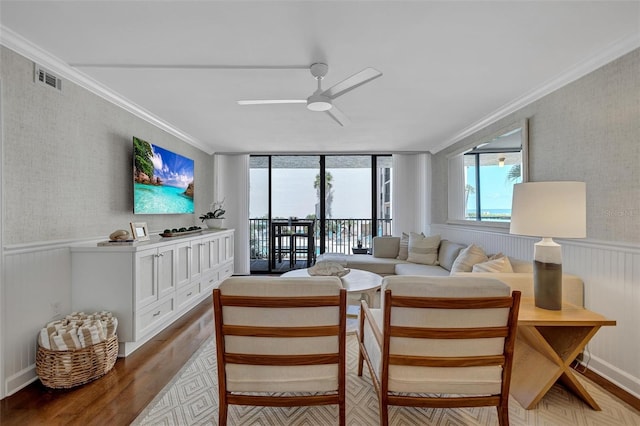 6480 Midnight Pass Rd Unit 211, Sarasota, FL 34242 - living room with crown molding, a ceiling fan, wood finished floors, wainscoting, and wallpapered walls