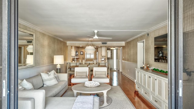 6480 Midnight Pass Rd Unit 211, Sarasota, FL 34242 - living room with wainscoting, wood finished floors, ceiling fan, and ornamental molding