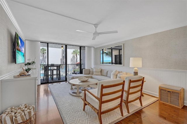 6480 Midnight Pass Rd Unit 211, Sarasota, FL 34242 - living area featuring crown molding, hardwood / wood-style floors, ceiling fan, and wainscoting