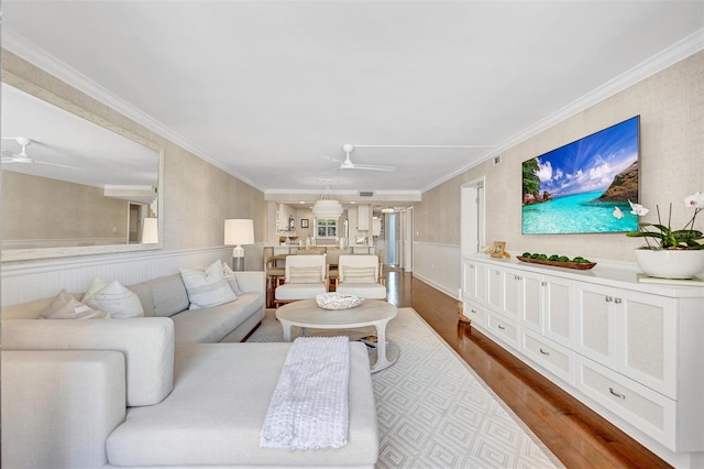 6480 Midnight Pass Rd Unit 211, Sarasota, FL 34242 - living area featuring a ceiling fan, dark wood-style floors, a wainscoted wall, and ornamental molding