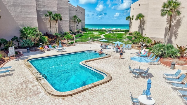 6480 Midnight Pass Rd Unit 211, Sarasota, FL 34242 - community pool featuring a water view and a patio area