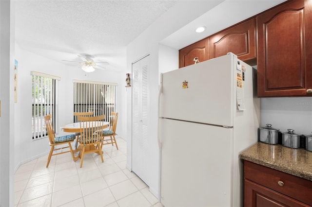 4415 45th Ave W Unit 102, Bradenton, FL 34210 - kitchen featuring freestanding refrigerator, ceiling fan, dark countertops, and a textured ceiling