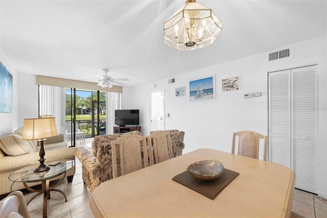 4415 45th Ave W Unit 102, Bradenton, FL 34210 - dining space with light tile patterned floors, a chandelier, and a ceiling fan