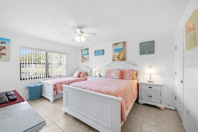 4415 45th Ave W Unit 102, Bradenton, FL 34210 - bedroom with light tile patterned flooring, a textured ceiling, and a ceiling fan