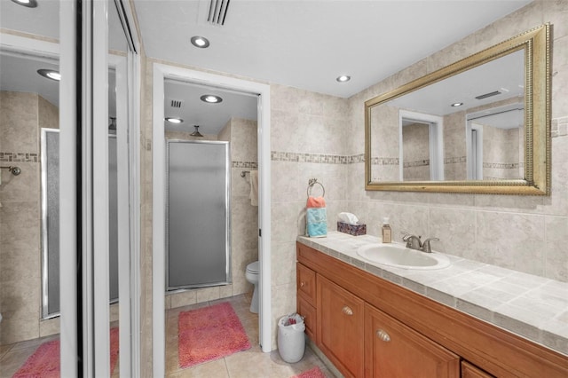 4415 45th Ave W Unit 102, Bradenton, FL 34210 - bathroom featuring vanity, a shower stall, tile patterned floors, tile walls, and recessed lighting