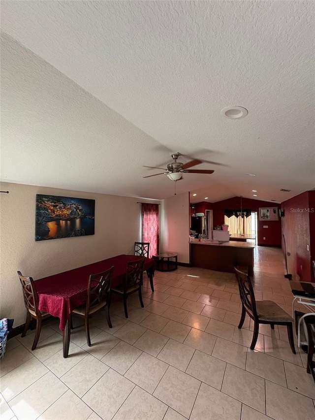 712 W Myrtle St, Lakeland, FL 33815 - dining area with vaulted ceiling, a textured ceiling, a ceiling fan, and light tile patterned flooring