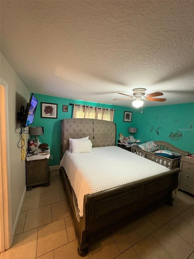 712 W Myrtle St, Lakeland, FL 33815 - bedroom with light tile patterned floors, ceiling fan, and a textured ceiling