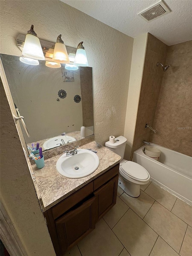 712 W Myrtle St, Lakeland, FL 33815 - full bath with a textured ceiling, a textured wall, vanity, tile patterned floors, and tub / shower combination