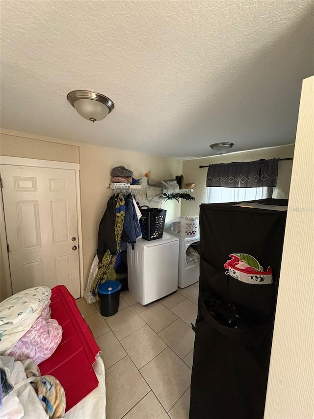 712 W Myrtle St, Lakeland, FL 33815 - laundry room with washer and dryer, light tile patterned floors, and a textured ceiling