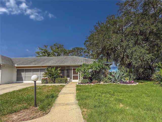 8606 Gold Pine Dr, Port Richey, FL 34668 - ranch-style home featuring driveway, a front lawn, a garage, and stucco siding