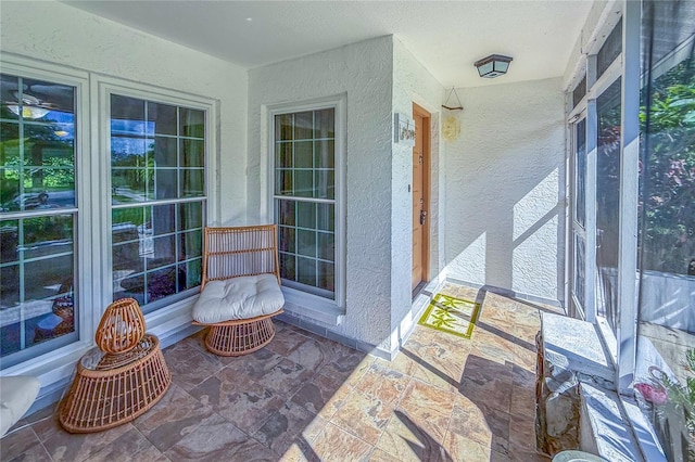8606 Gold Pine Dr, Port Richey, FL 34668 - sunroom / solarium featuring a textured wall and stone finish flooring